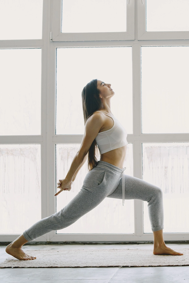 A woman standing on one leg in a pose